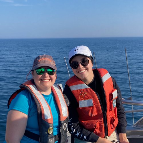 Two women on a boat in the ocean.