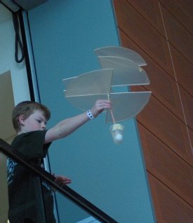 A student launches his helicopter off of a balcony in Syracuse University's Life Sciences Complex during the 2012 Mid-State Science Olympiad B Division tournament