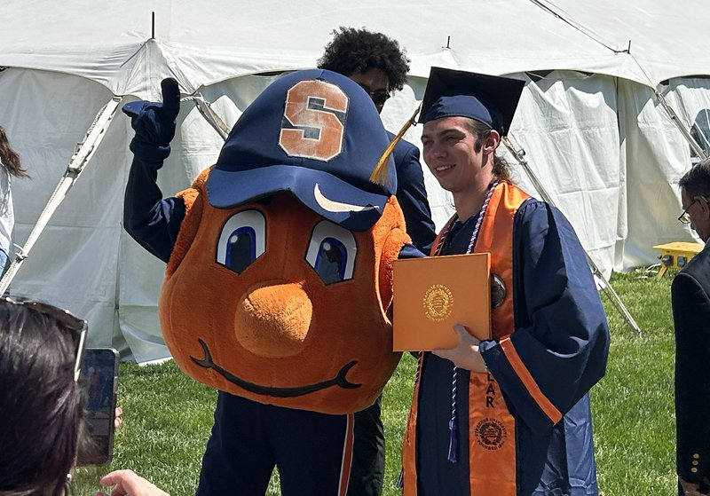 Otto the orange and a student.