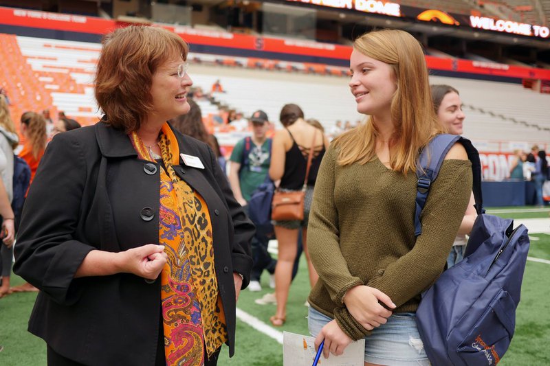 Karin Ruhlandt, left, speaks with a student during opening weekend.