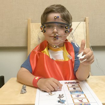 Child undergoing tests to examine the connection between excitement and speech motor control.