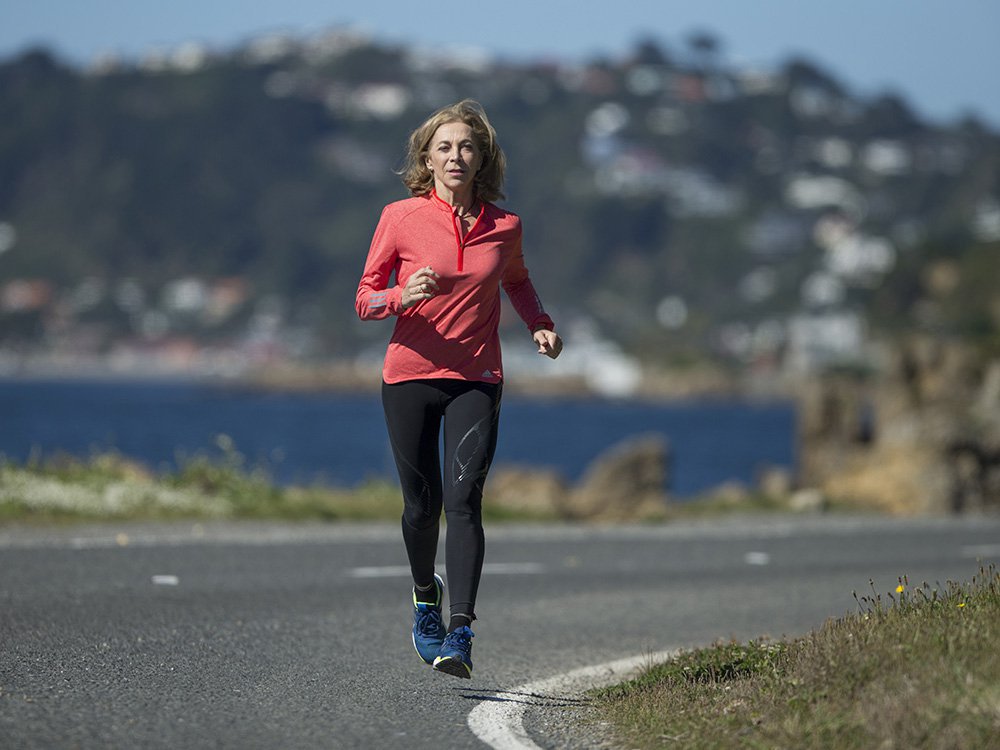 Katherine Switzer running on tarmac in New Zealand.