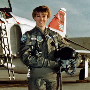 Eileen Collins standing in front of an aircraft.