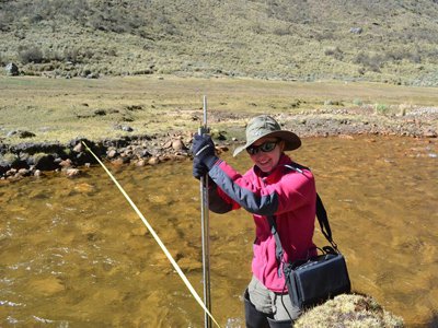 Baker taking data measurements of a mountain stream in Cordillera Blanca, Peru.