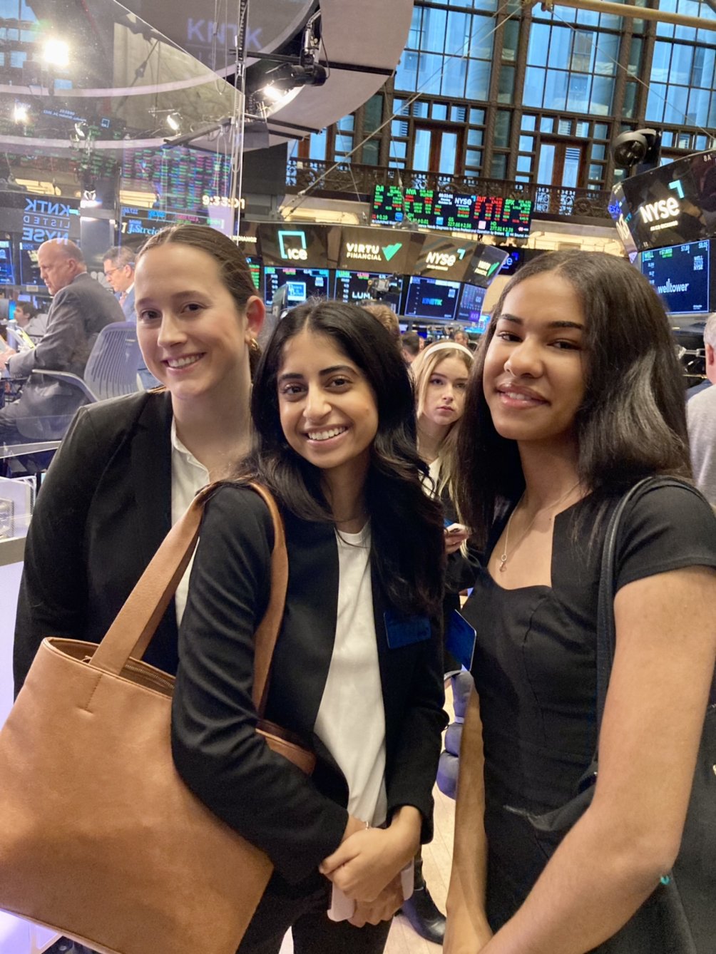 From left to right, students Sarah Jackson, Ashima Dhawan, and Karyne Brown had the special opportunity to walk the floor of the NYSE during trading hours.