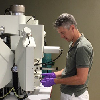 Professor Jay Thomas changing samples in the Cameca SX5 electron microprobe.