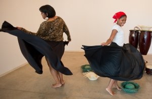 Luz Encarnacion (left) teaches Kimberly Sepio how to Bomba dance at La Casita Cultural Center