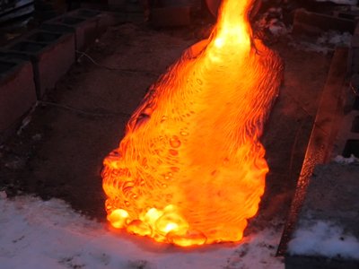 Lava flows from the specially modified furnace located at the Comstock Art Facility at Syracuse University.