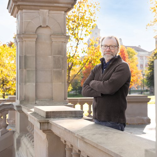 George Saunders standing on the steps in front of Hall of Languages.
