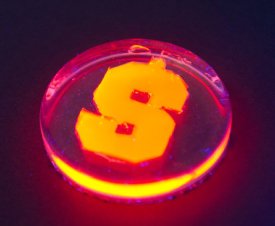 Nanorods created with firefly enzymes glow orange. The custom, quantum nanorods are created in the laboratory of Mathew Maye, assistant professor of chemistry.