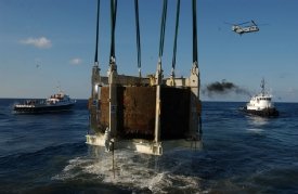 USS Monitor turret being raised from the Atlantic. The remains of two crew members, discovered in the turret, will be interred at Arlington National Cemetery on March 8, 2013.  Image courtesy of NOAA