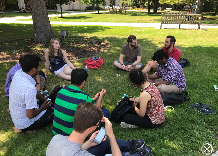 Students in a circle on the quad.