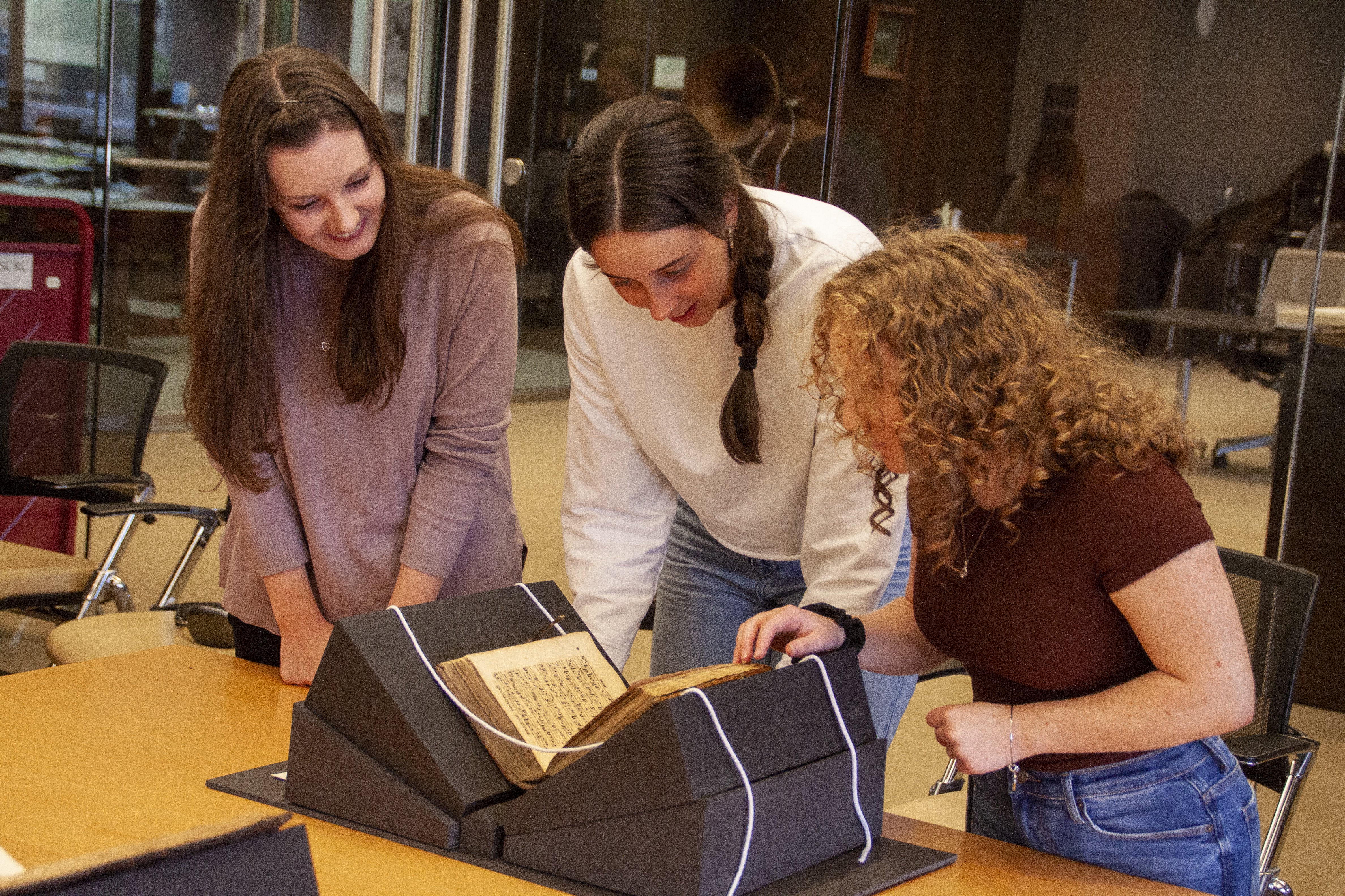 Students examine a book