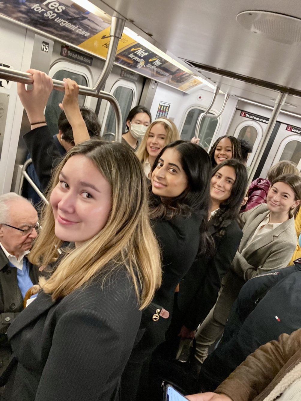 Students riding on the subway from their hotel to the Financial District.