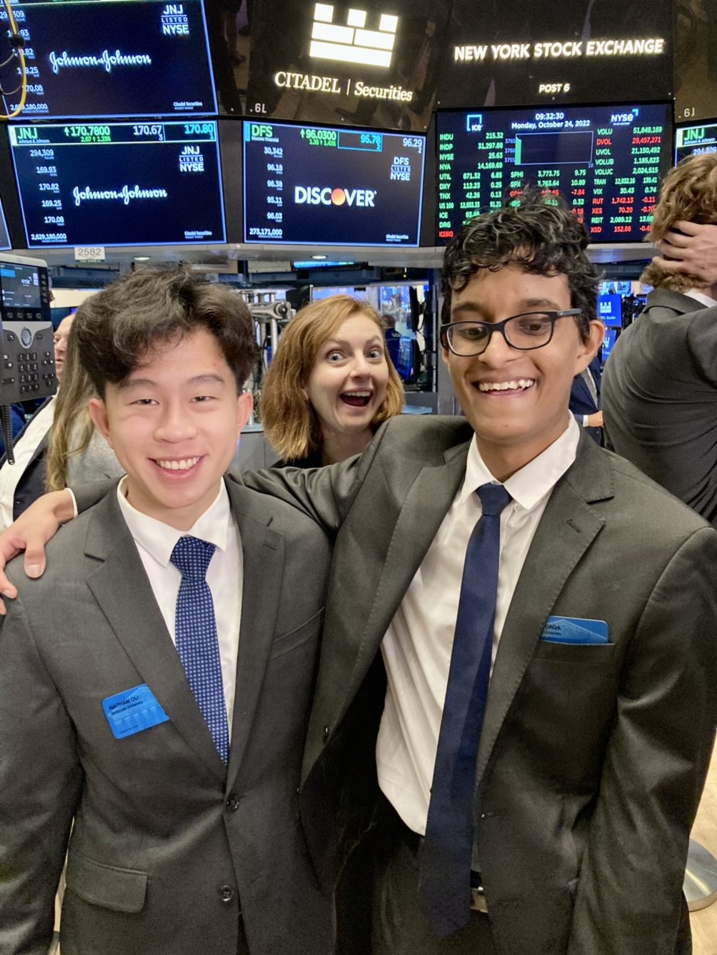 Students Nathan Ou (left) and Aryan Daga (right) with Academic and Career Advisor Rachael Vines (center) on the floor of the NYSE.