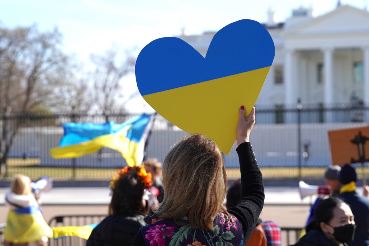 A demonstrator in Washington, D.C. holding a heart painted with the colors of the Ukrainian national flag.