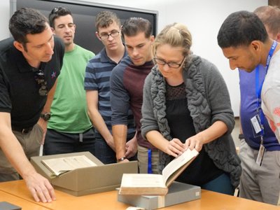 Students in the Warrior Scholar Program at Syracuse spend time exploring the resources available in the special collections archive of Bird Library.