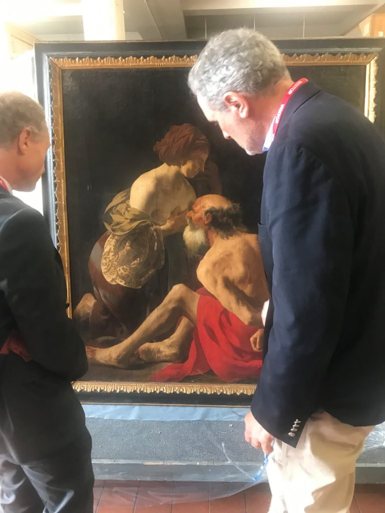 Title slide showing prof Wayne Franits inspecting the painting “Roman Charity”