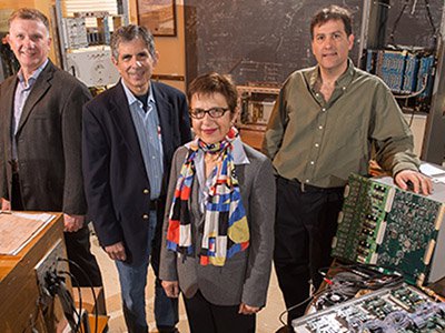 Sheldon Stone (second from left) with professors Tomasz Skwarnicki, Marina Artuso and Steven Blusk, all members of Syracuse's High-Energy Physics Group. Not pictured is Matthew Rudolph, the group's newest member.
