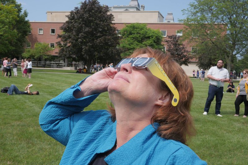 Karin Ruhlandt wearing glasses observing an eclipse.