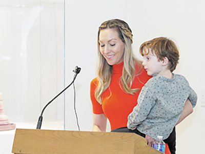 Danial holding her son at the dedication of her eponymous education center.  (Everson Museum of Art)