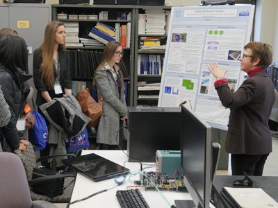 Marina Artuso (right), a world-renowned particle physicist at Syracuse, discusses her research with CUWiP participants