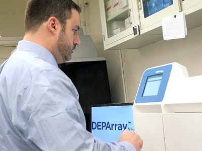 Research Assistant Professor Michael Marciano sets up the next experiment on the DEPArray