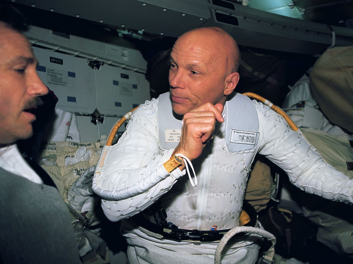 Franklin Story Musgrave in his astronaut suit with his helmet off.