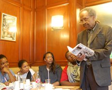 Poet James Emanuel reads to students at the renowned Cafe de Flore.