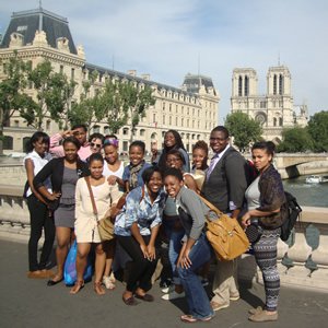 Paris Noir seminar students pose on Pont Saint-Michel, with Notre Dame Cathedral in the background.