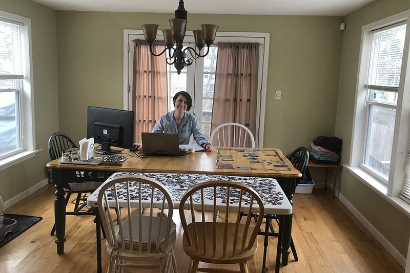 woman at table with laptop and puzzle