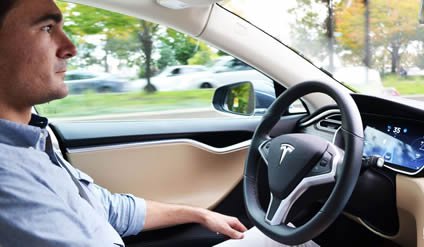 Sorokanich experimenting with Tesla's semi-autonomous Autopilot in the Model S. (Courtesy of Road & Track)