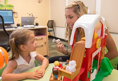A graduate-student clinician works with a child in the Stuttering Research Lab. 