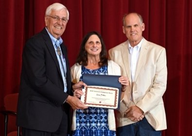 DeMar receiving the 2017 Community Engagement Staff Award from NMSU President Gary Carruthers (left) and geography professor John Wright. 