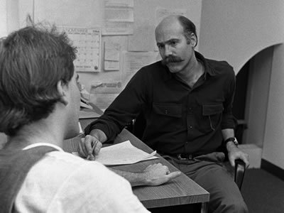 Wolff consulting with a student, 1984 (Photo courtesy of Syracuse University Archives)